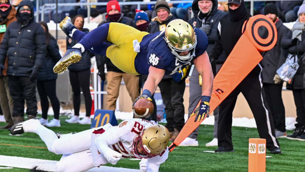 Nov 19, 2022; South Bend, Indiana, USA; Notre Dame Fighting Irish tight end Michael Mayer (87) dives for the pylon as Boston College Eagles defensive back Josh DeBerry (21) defends in the first quarter at Notre Dame Stadium. Mandatory Credit: Matt Cashore-USA TODAY Sports